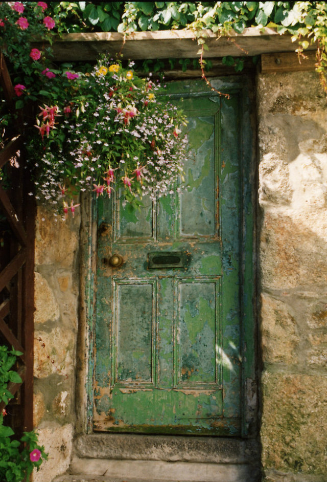 Unbelievably Beautiful Doors from Around the World  Unbelievably Beautiful Doors from Around the World Green old door with flowers and rock wall