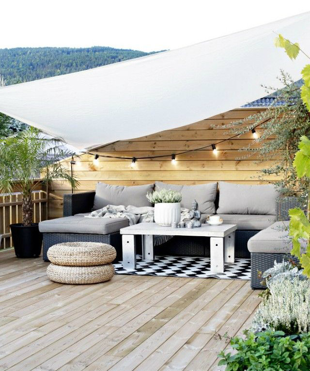 Rooftop Exciting Styles  Rooftop Exciting Styles and Inspirations Rootop ideas grey sofa white tent straw stools black white carpet string lights1