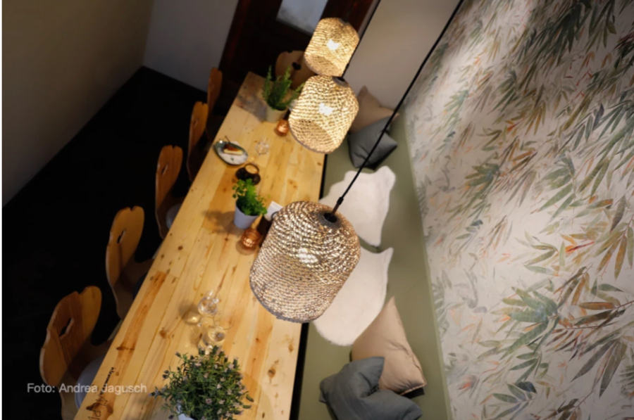 Casa Coulon- Interior Design Inspirations for Your Home RESTAUANT TOGATHER overview of a table with 3 ceiling lamps, cozy pillows and a sofa around the table.  casa coulon Casa Coulon- Interior Design Inspirations for Your Home Captura de ecra   2021 11 19 a  s 16