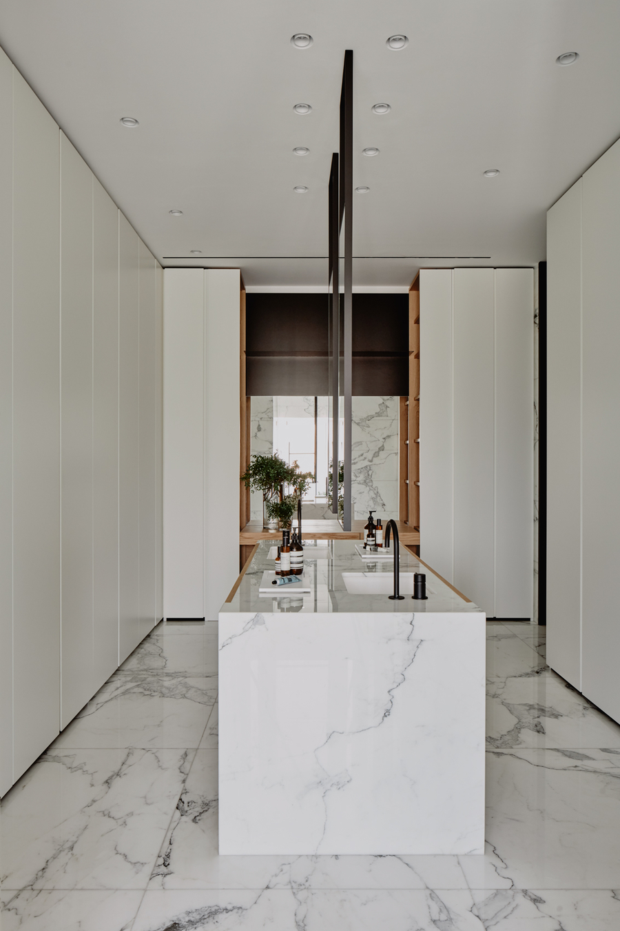 A modern kitchen with the floor made out of marble, so as the center counter. vshd design VSHD Design &#8211; Minimalist Interior Designs Inspirations Webp